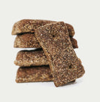 Stack of brown radical dog premium dog biscuits on a white background